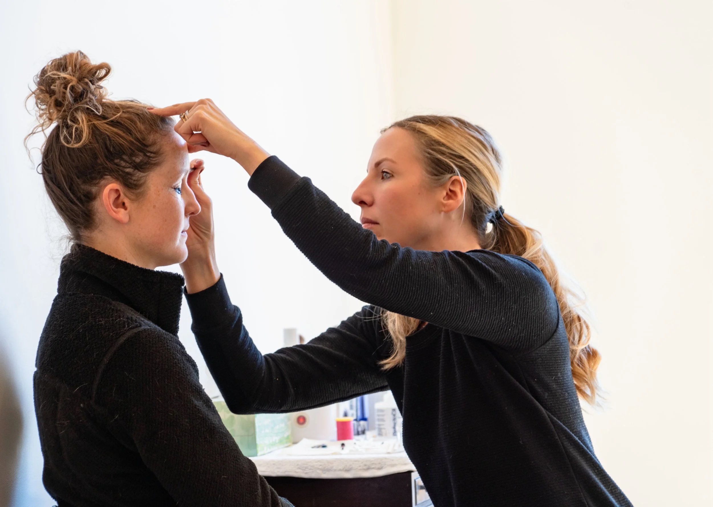 Merritt shaping a client's brows at AlpineGold in Truckee